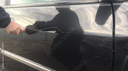 Mad person keys car door vandalism and scratches up paint job thereafter.