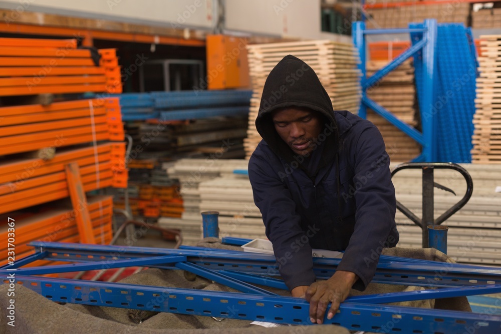 Worker arranging pallet rack Worker arranging pallet rack