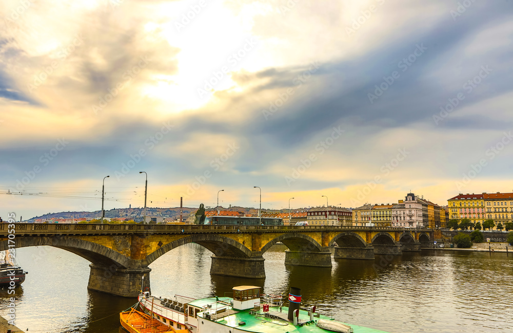 City view from bridge and traditional Czech architecture of antique Prague buildings at autumn evening.