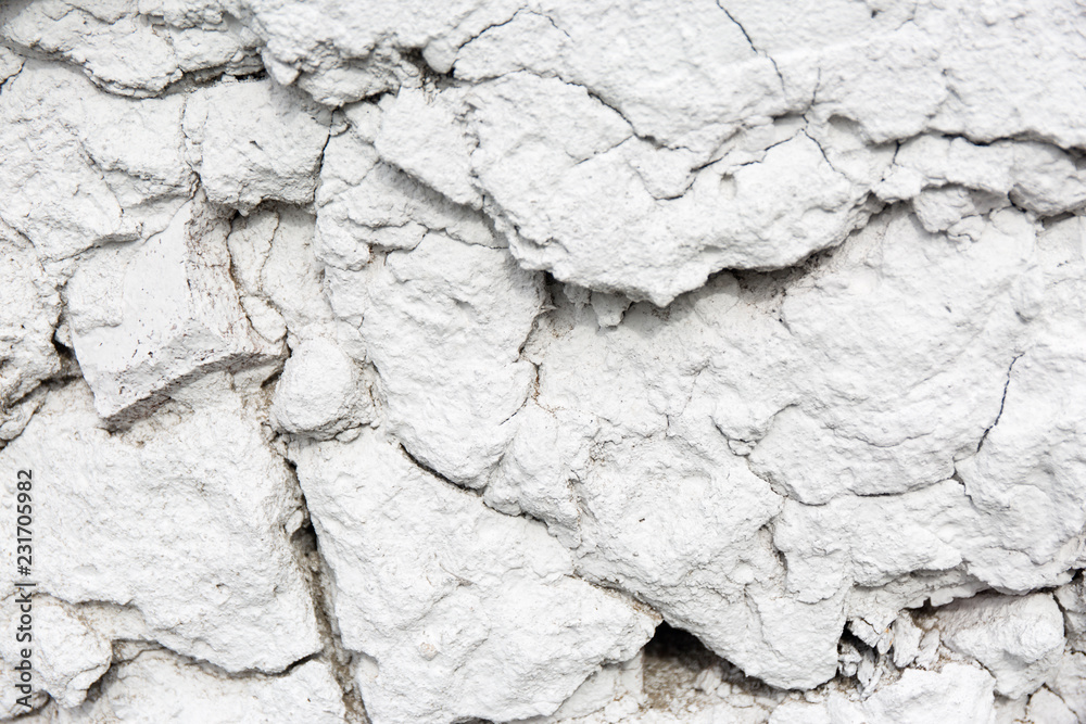 Old weathered white plaster wall texture. Grunge background. Old weathered white plaster wall texture. Grunge background.