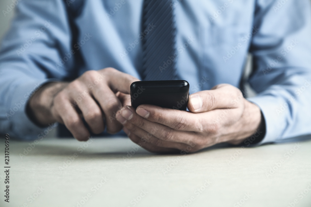 Man using smartphone in his desk. Business concept Man using smartphone in his desk. Business concept