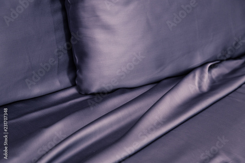 Beautiful bedding on the bed with expensive dark black silk