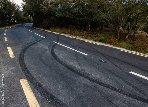 Car tyre skid marks on a rural road photo