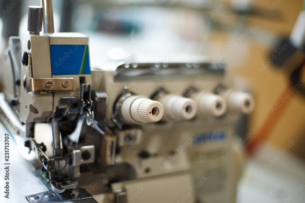 closeup details on sewing machine overlock. Workplace seamstress.Tailoring industry closeup details on sewing machine overlock. Workplace seamstress.Tailoring industry