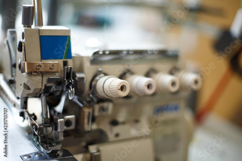 closeup details on sewing machine overlock. Workplace seamstress.Tailoring industry