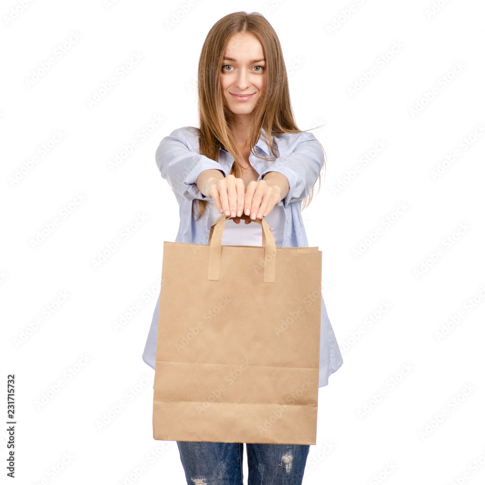 Woman holding a paper bag shopping beauty on a white background. Isolation Woman holding a paper bag shopping beauty on a white background. Isolation