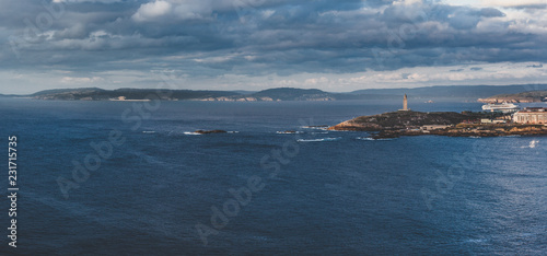The Tower of Hercules lighthouse and cruise ship entering in th port of A Coruña. Galicia, Spain.