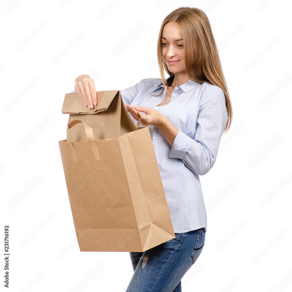 Woman holding a paper bag package shopping beauty on a white background. Isolation Woman holding a paper bag package shopping beauty on a white background. Isolation