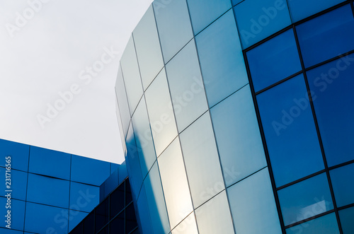 facade of an office building with blue walls and mirrored windows