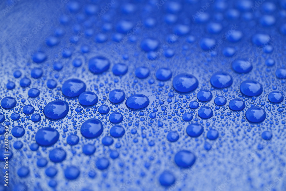 Closeup waterdrops on blue ceramic coated paint surface Closeup waterdrops on blue ceramic coated paint surface