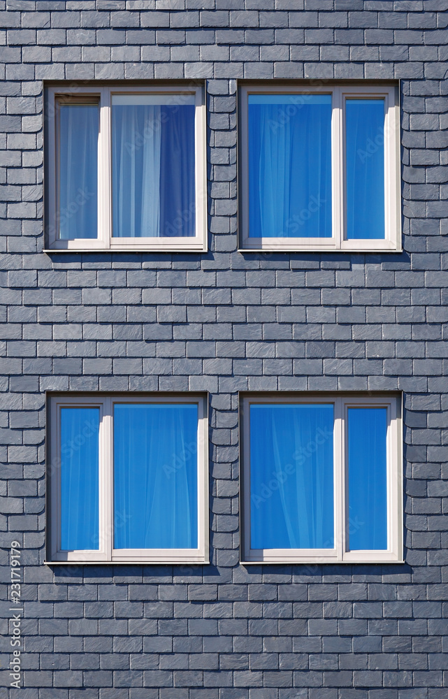 the wall of the house is decorated with tiles of black Silesian slate