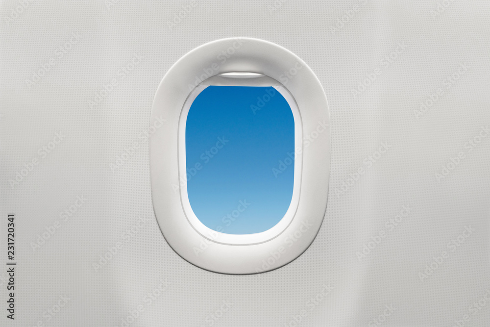 Isolated airplane window with blue sky Isolated airplane window with blue sky