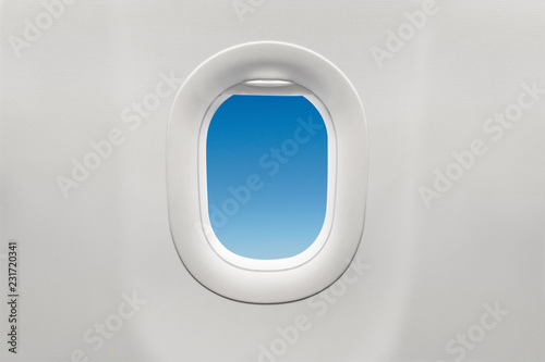 Isolated airplane window with blue sky