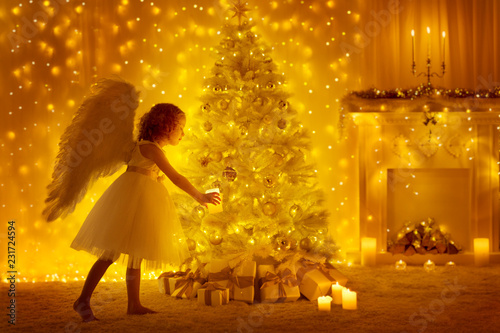 Christmas Tree and Angel Child with Candle, Girl Decorating Presents in Holiday Room with Fireplace