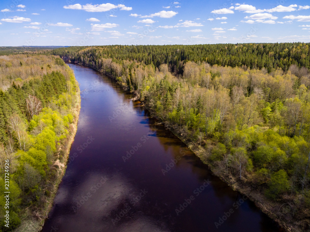 drone image. aerial view of rural area with fields and forests with river and water reflections