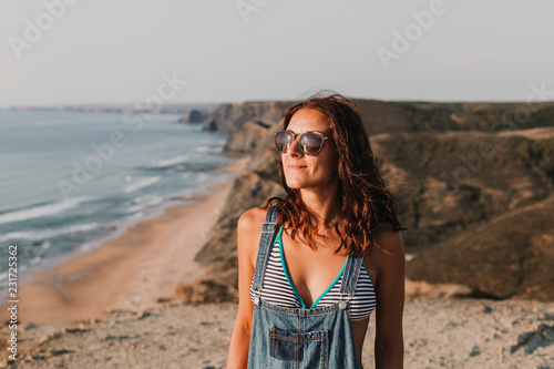 portrait of a beautiful happy young woman relaxing on the top of a hill. Summer time. Lifestyle
