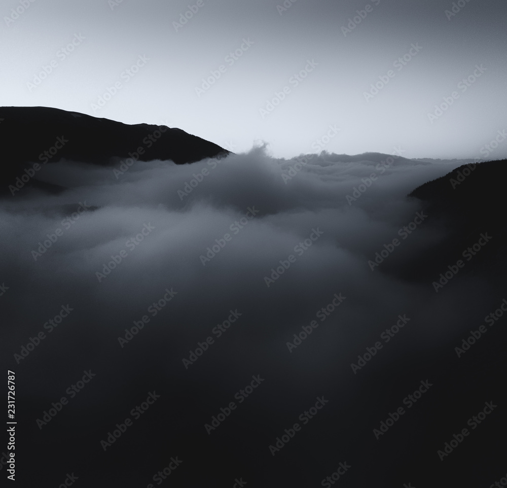 Sunset.  Aerial/Drone photograph of fog/clouds in a mountain valley.  Taken in the Colorado Rocky Mountains