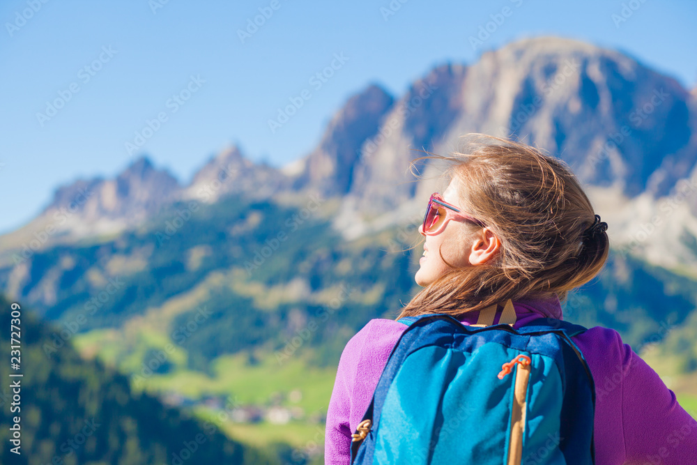 Young smiling woman hiking at Alta Badia, Dolomites, Italy