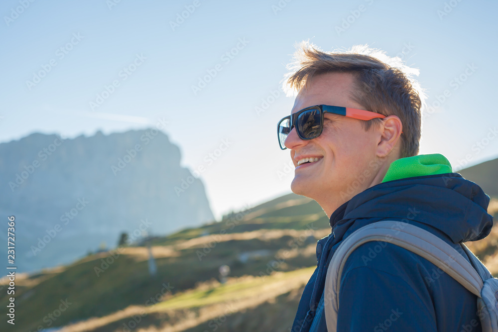portrait of young smiling man hiking in Alta Badia, Dolomites