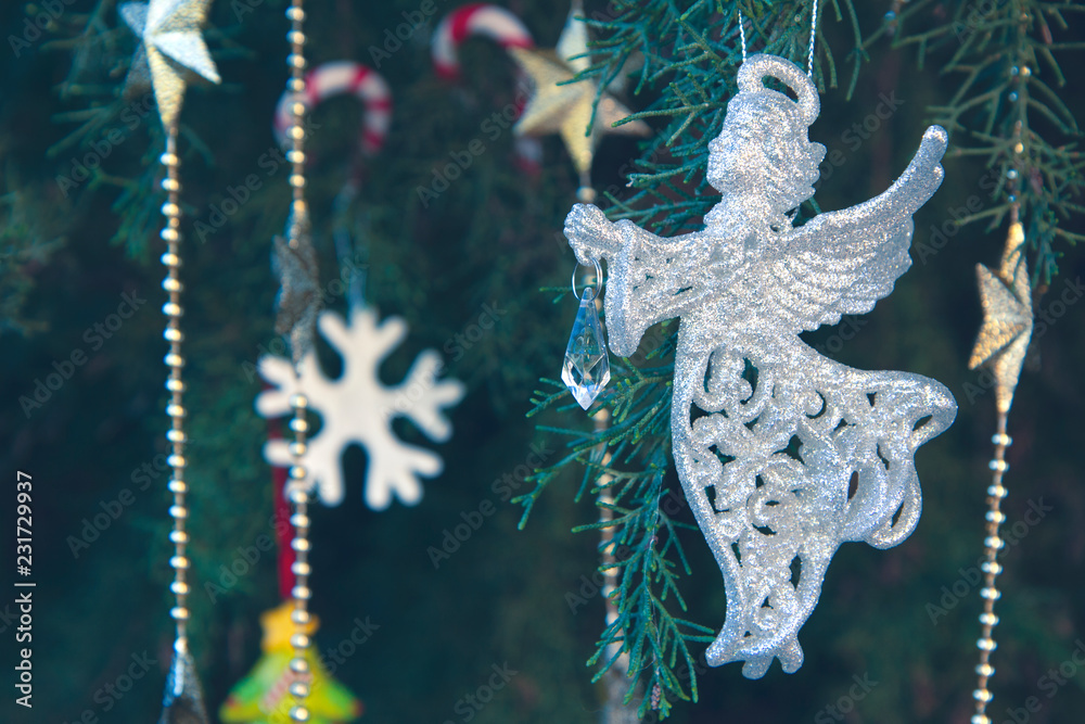 Shiny silver angel, snowflake, necklace of golden stars, candy canes, Christmas tree branches. Christmas and New Year holiday background concept. Copy space for text. Shiny silver angel, snowflake, necklace of golden stars, candy canes, Christmas tree branches. Christmas and New Year holiday background concept. Copy space for text.