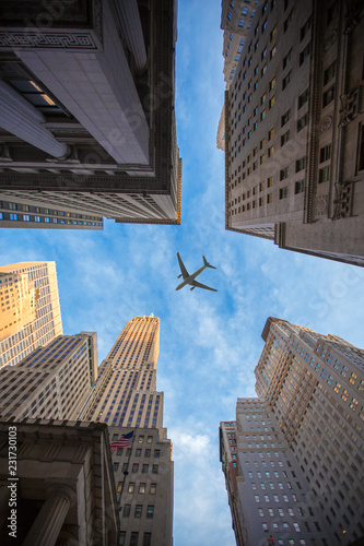 plane flies over the city over New York © Aliaksei