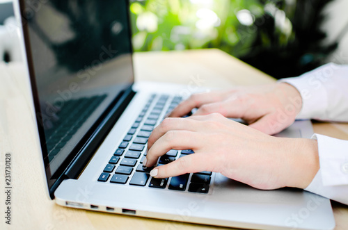 Female fingers on a laptop trackpad close-up photo