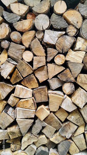 Firewood pile stacked chopped wood trunks