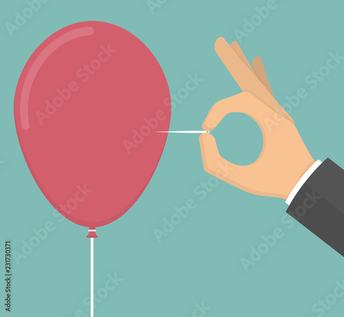 Hand pricking or popping out a red balloon with a needle