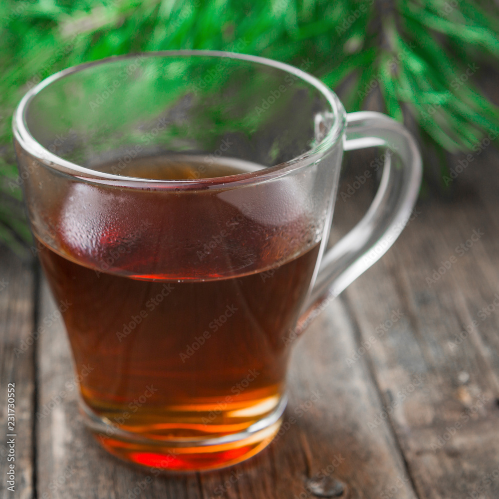Tea in glass cup on wooden table background. Tea in glass cup on wooden table background.