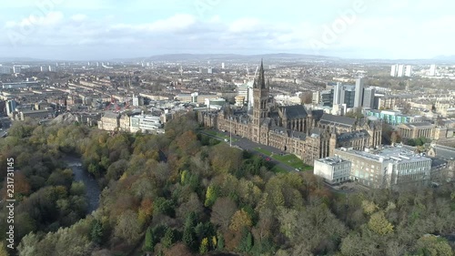 Aerial footage from over Kelvingrove Park in Glasgow. Flying right with view of Kelvingrove park, River Kelvin, Glasgow University Tower and the cityscape. photo