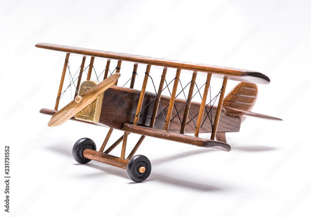 Retro wooden airplane isolated on white background. Travel concept Retro wooden airplane isolated on white background. Travel concept