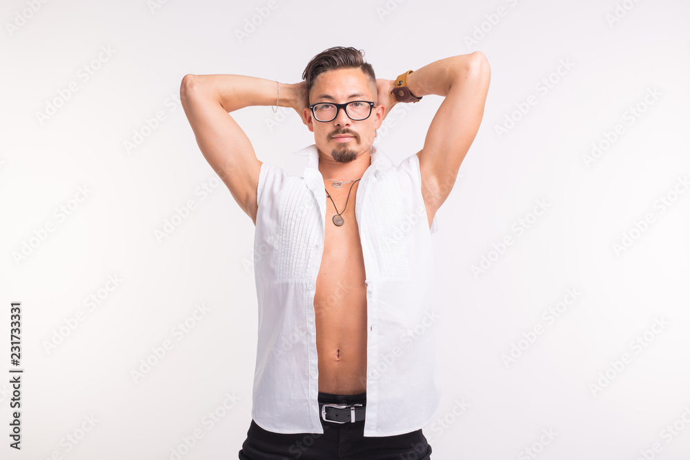 People, clothing and style concept - young sexy handsome man posing in white shirt on white background People, clothing and style concept - young sexy handsome man posing in white shirt on white background
