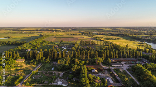 Aerial view of the fresh bright green lush countryside at sunset © LALSSTOCK