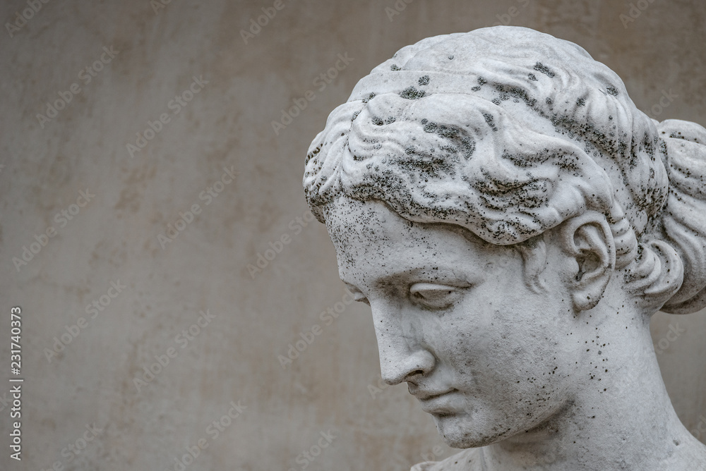 Ancient statue of sensual Greek renaissance era woman with a flower, Potsdam, Germany, details, closeup