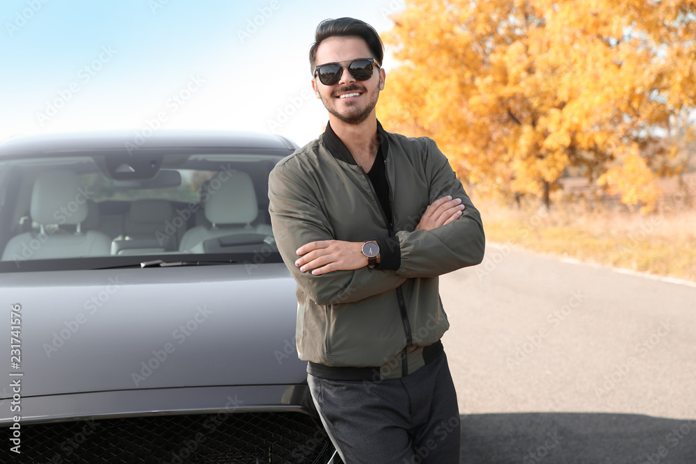 Young man near modern car on sunny day, outdoors Young man near modern car on sunny day, outdoors