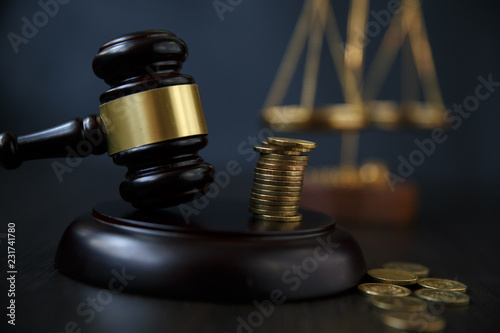 фотографія legal gavel and coins in a coin jar