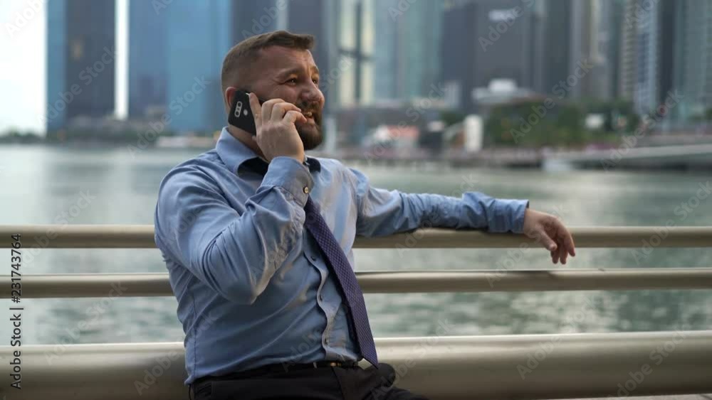 Young handsome businessman talking on cellphone in the city Young handsome businessman talking on cellphone in the city