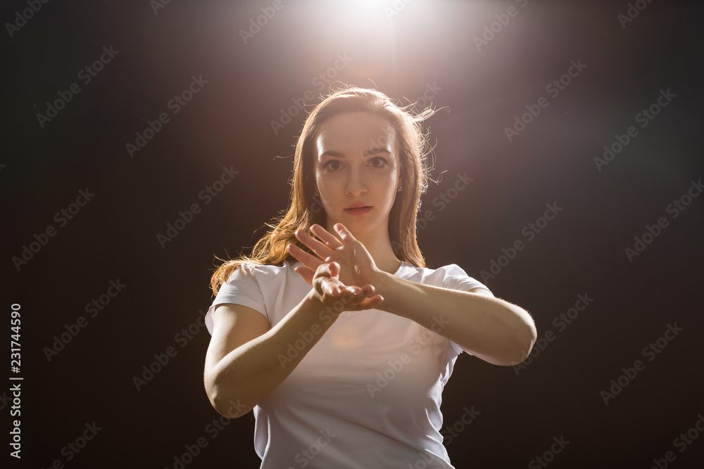 Fototapeta premium Hip-hop, jazz-funk, tecktonik, waacking, trance and street dances concept - Young woman dancing jazz-funk at studio