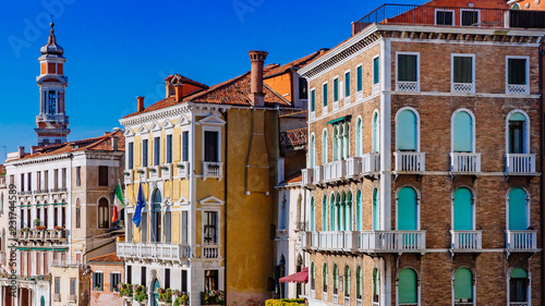 Venetian houses and tower by Grand Canal, viewed from Rialto Bridge, in Venice, Italy