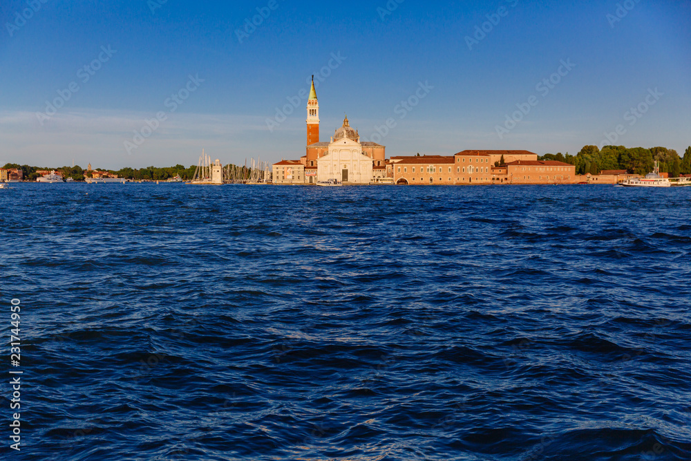 San Giorgio Maggiore church and bell tower over water at sunset, in Venice, Italy