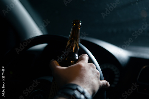 Drunk driver. Man drinking beer while driving a car © burdun