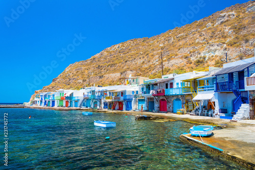 Scenic Klima village (traditional Greek village by the sea, the Cycladic-style) with sirmata - traditional fishermen's houses, Milos island, Cyclades, Greece. photo