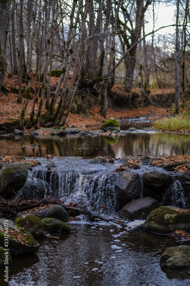 waterfall over the rocks in river stream in forest waterfall over the rocks in river stream in forest