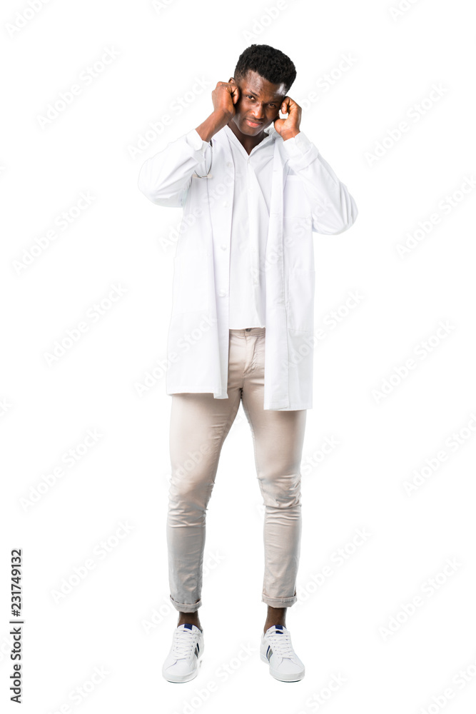 Full body of African american doctor covering both ears with hands. Frustrated expression on white background Full body of African american doctor covering both ears with hands. Frustrated expression on white background
