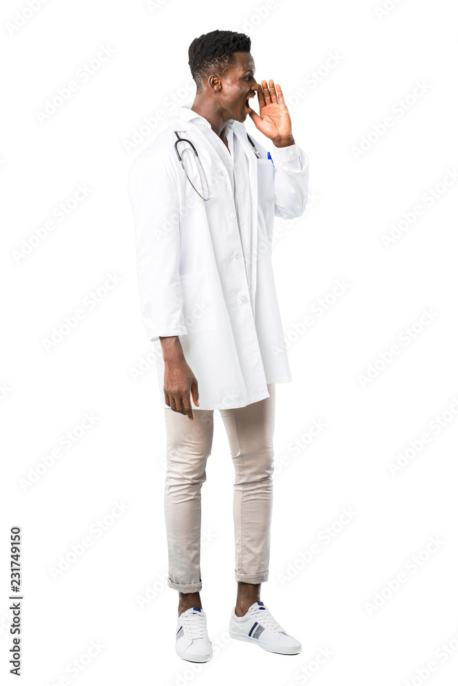 Full body of African american doctor shouting with mouth wide open to the lateral and announcing something on white background