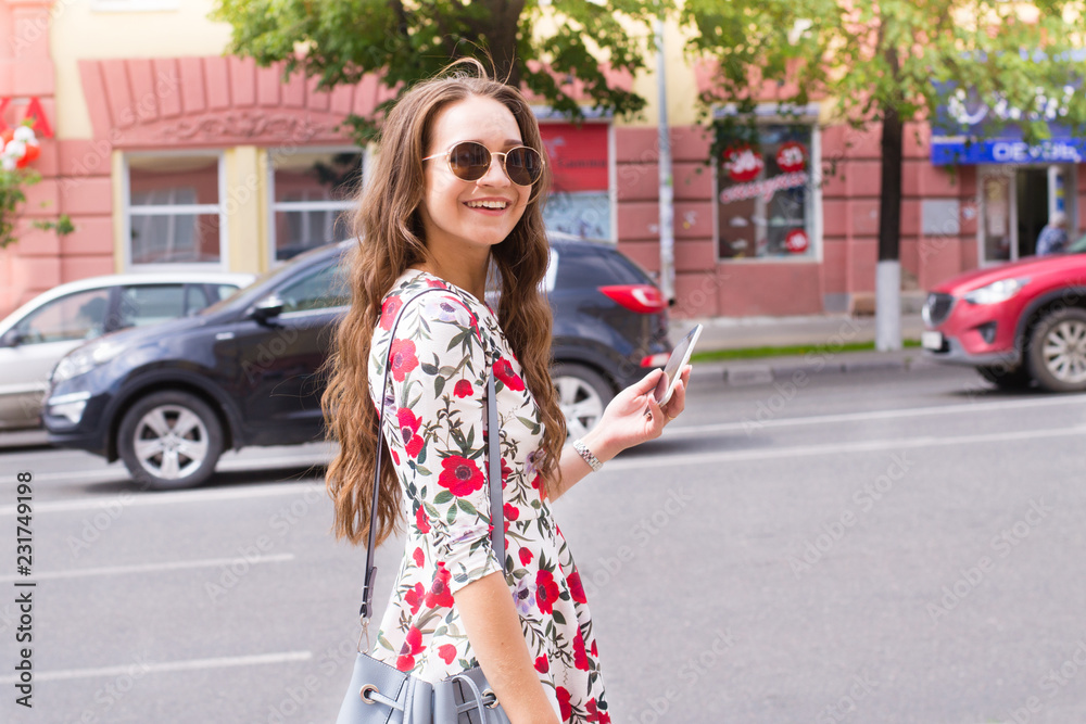 Fototapeta premium Girl with phone in city