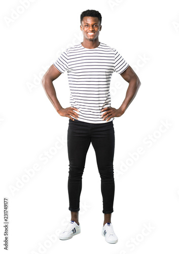 Full body of Dark skinned man with striped shirt posing with arms at hip on white background