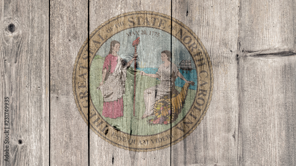 Obraz premium USA Politics News Concept: US State North Carolina Seal Wooden Fence Background
