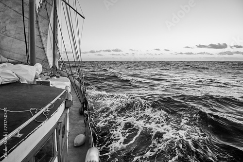 Black and white picture of an old sailing ship cruise.