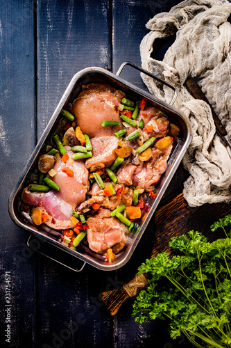 Prepared for baking chicken meat with vegetables.